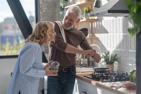 Premium Photo A Mature Couple In The Kitchen Cooking Together