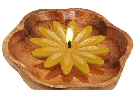 A Wooden Bowl With A Candle In The Center On A White Background It