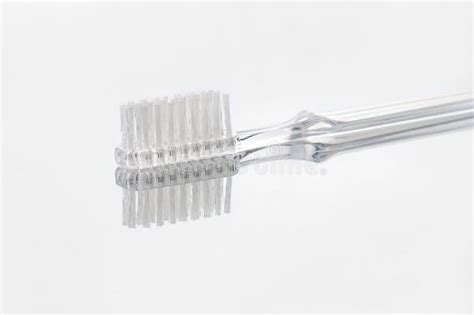 Transparent Toothbrush With Reflection On Gray Background Selective