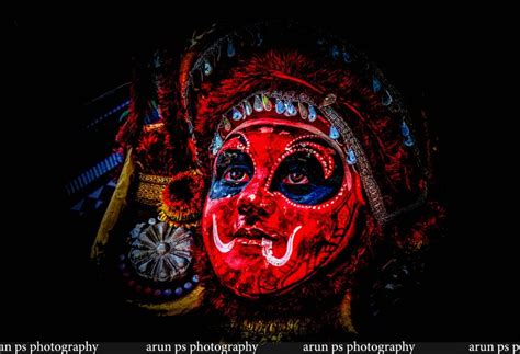 an image of a woman with red and blue painted on her face in the dark