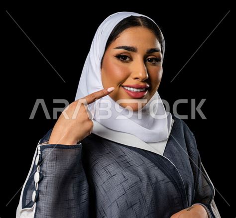 Portrait Of A Saudi Arabian Gulf Woman Wearing A Saudi Abaya Pointing