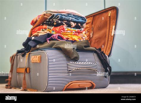 Open Suitcase Full Of Clothes In Room Stock Photo Alamy