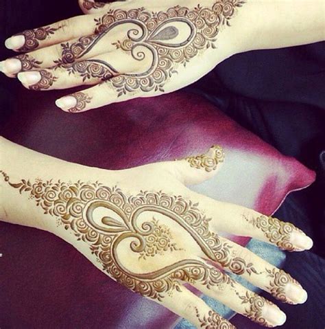 Two Hands With Henna Tattoos On Them