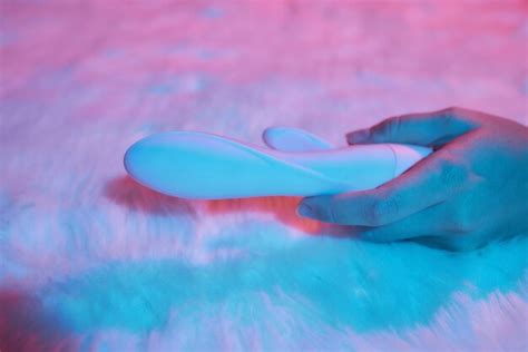 Premium Photo Desire Concept Woman Lying In Bed Holding A Dildo Vibrator In Her Hand To Help