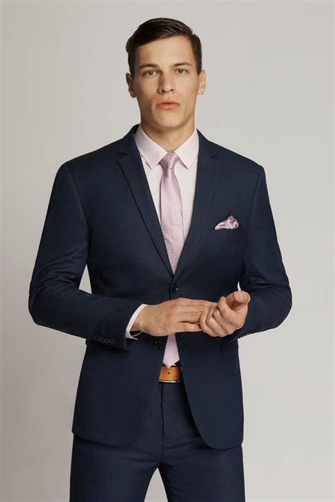 Modern Slim Fit Navy Suit Complimented With A Pink Shirt And Tie Ideal