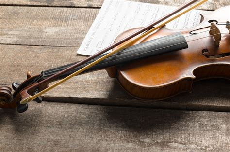 Premium Photo Sheet Music And Violin On Wooden Table