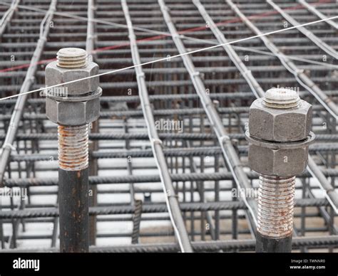 Two Steel Anchor Bolts With Screw Nuts And Steel Grid On Tower Crane