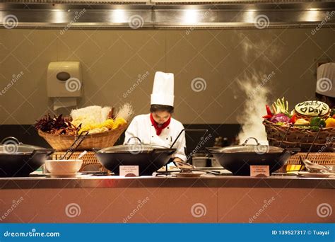 Chef And Assistant Chefs Cooking And Prepared Buffet Food At Restaurant