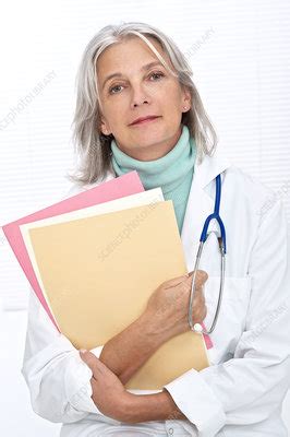 Mature Female Doctor Holding Files Stock Image F011 7698 Science