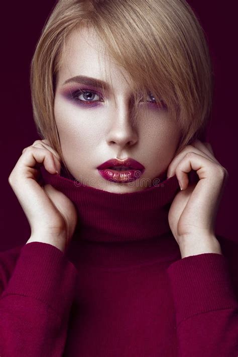 Beautiful Blonde Woman In A Red Sweater With Bright Makeup And Dark Lips Beauty Face Stock