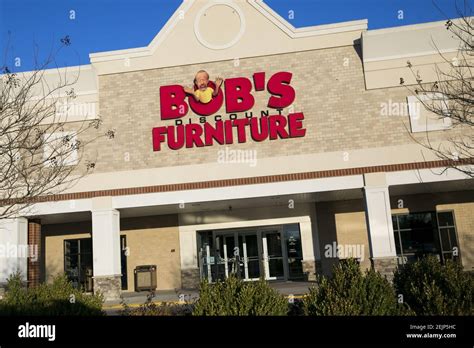 A Logo Sign Outside Of A Bobs Furniture Retail Store Location In