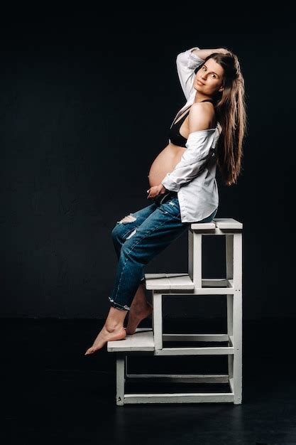 Premium Photo Pregnant Woman Sitting On A Ladder Chair In A Studio On