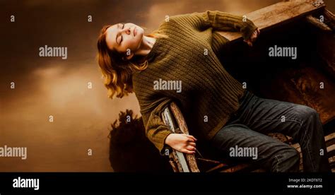 A Beautiful Blonde Woman Lies In An Old Fishing Boat Relaxing With Her