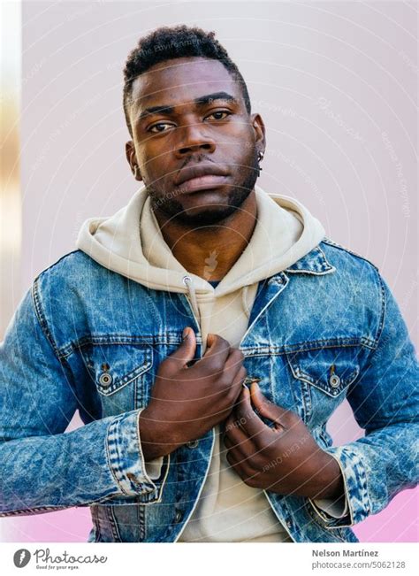 Portrait of black man with casual clothes on pink background - a ...