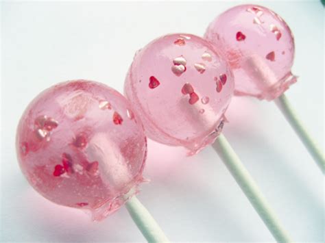 Three Pink Lollipops Sitting On Top Of Each Other