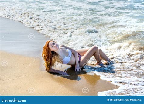 Beautiful Girl In Bikini Posing On A Deserted Beach White Sand