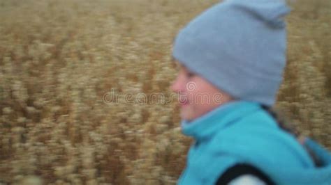 Baby Girl Walking In Wheat Field Kid Runs Against The Backdrop Of