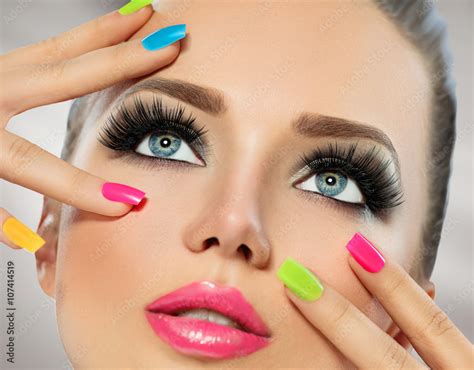 Beauty Girl Face With Colorful Nail Polish Manicure And Makeup Stock