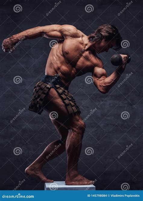 Beautiful Strong Bodybuilder Is Posing On White Pedestal With Naked Torso Dumbbell And