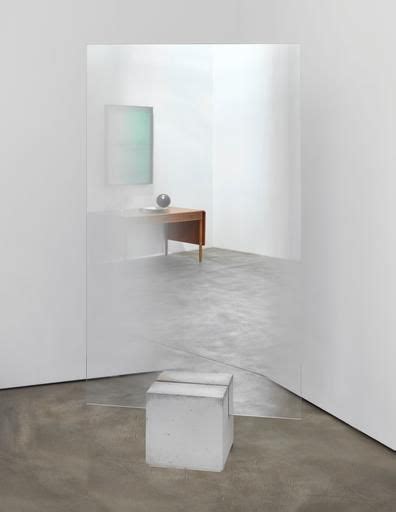 An Empty Room With White Walls And A Small Table In The Corner As Well