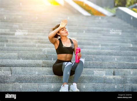 Tired African Sporty Girl Resting On Stairs At Park Stock Photo Alamy