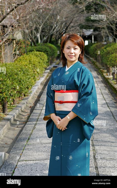 Beautiful Japanese Woman Wearing Traditional Kimono Poses In Kyoto