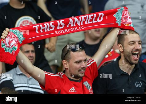 Liverpool Supporter With This Is Anfield Scarf Shows His Support During