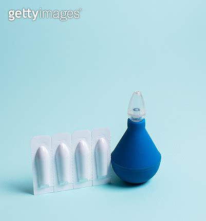 Enema And Suppository For Anal Or Vaginal Use On A Blue Background