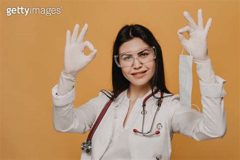 Female Doctor With Phonendoscope On Her Neck Dressed In A Scrubs