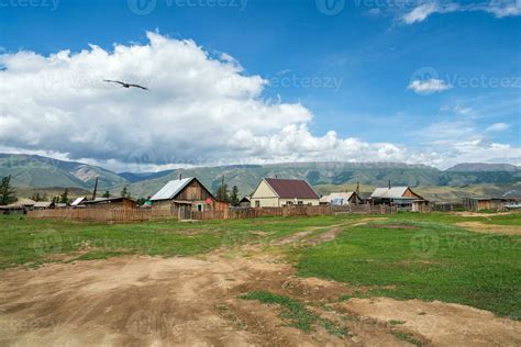 Russian siberian village with dirt road and traditional ancient wooden