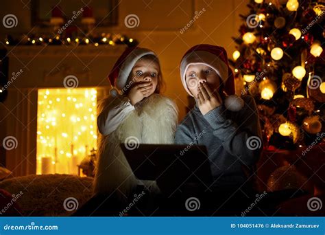 Amazed Children Using Tablet Near Christmas Tree Stock Photo Image Of