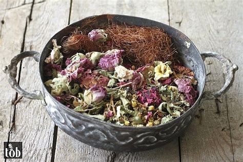 A Metal Bowl Filled With Lots Of Different Types Of Flowers