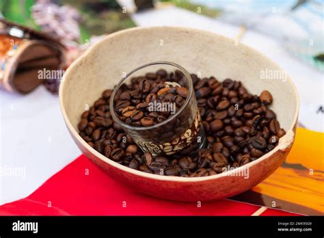 A Clear Glass Cup Filled With Coffee Beans Perfect For Enjoying A Hot