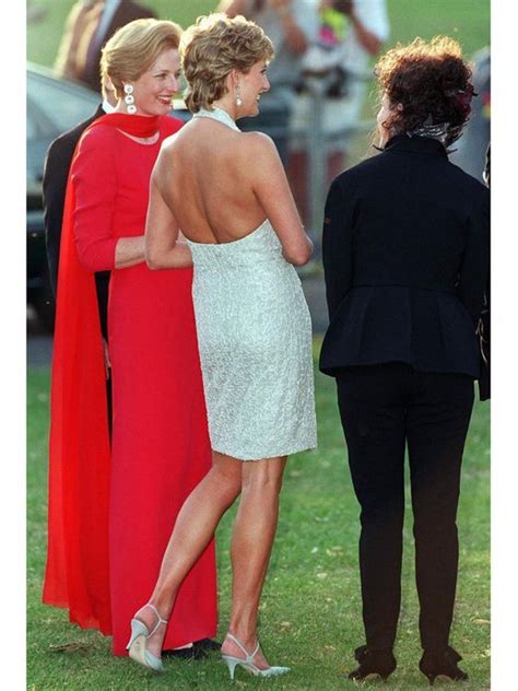 Two Women In Red And White Dresses Standing Next To Each Other On The