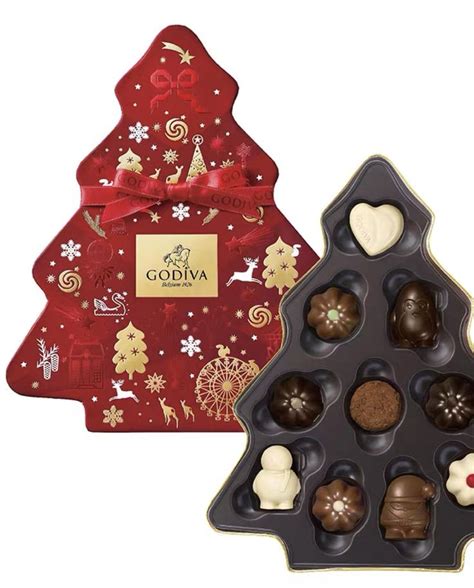 An Assortment Of Chocolates In A Christmas Tree Shaped Box