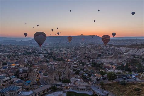 Early Morning Aerial View Of Hot Air Balloons Above Goreme Village In