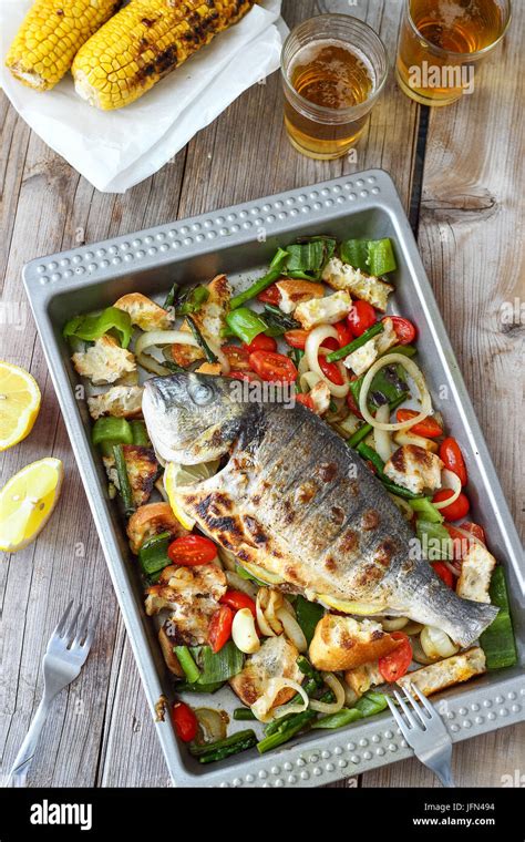 Grilled Whole Fish with Mediterranean Salad Stock Photo - Alamy