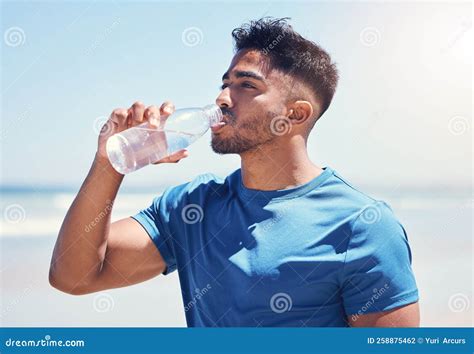 Live Exercise And Drink Water A Man Drinking Water While Out For A