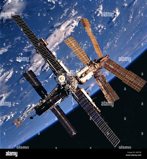 View of Russian Mir Space Station backdropped against a cloud-covered ...