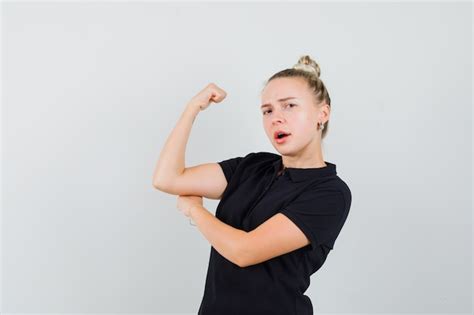 Free Photo Blonde Lady Showing Muscles Of Arm In Black T Shirt And