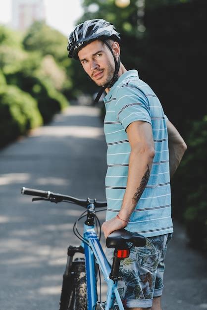 Free Photo Young Handsome Male Wearing Helmet Standing With Bicycle