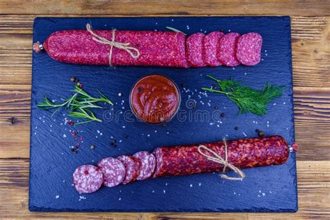 Sliced Dry Smoked Salami Sausage On A Slate Board Top View Stock Photo