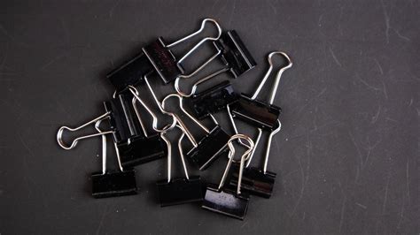 a black paper clip on a black background 15744260 Stock Photo at Vecteezy