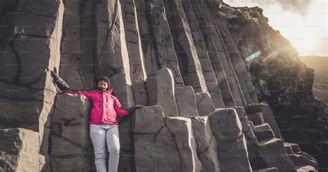 Traveler travel to unique volcanic rock formation on Iceland black sand ...