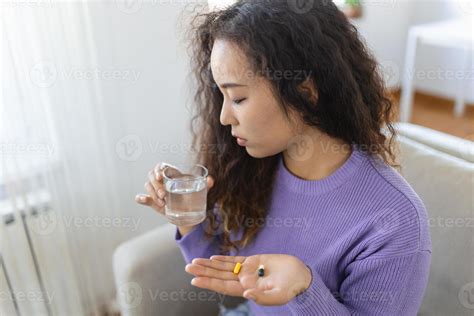 Asian ill sick woman taking painkiller medicine to relieve stomachache