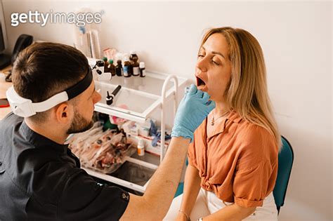 Oropharyngoscopy Procedure Otolaryngologist Examines Woman Throat With