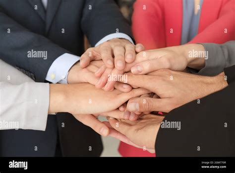 Group Of People Putting Hands Together As Symbol Of Unity Stock Photo