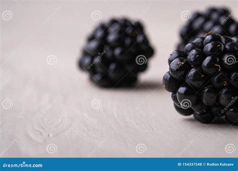 Three Blackberry Berries Macro Close Up On White Wooden Background