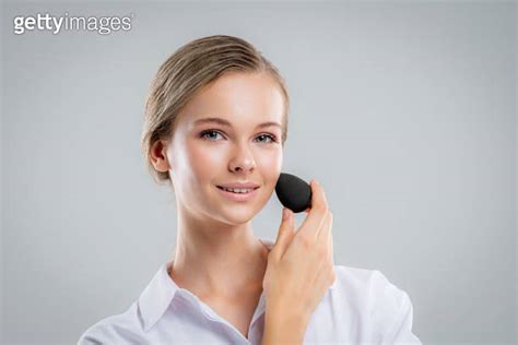 Cute Beautiful Natural Brunette Girl Cleaning Face With Cotton Sponge Smiling Looking At Camera