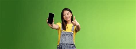 Free Photo Cheerful Satisfied Cute Asian Brunette Girl Pleased Awesome Smartphone Game Show
